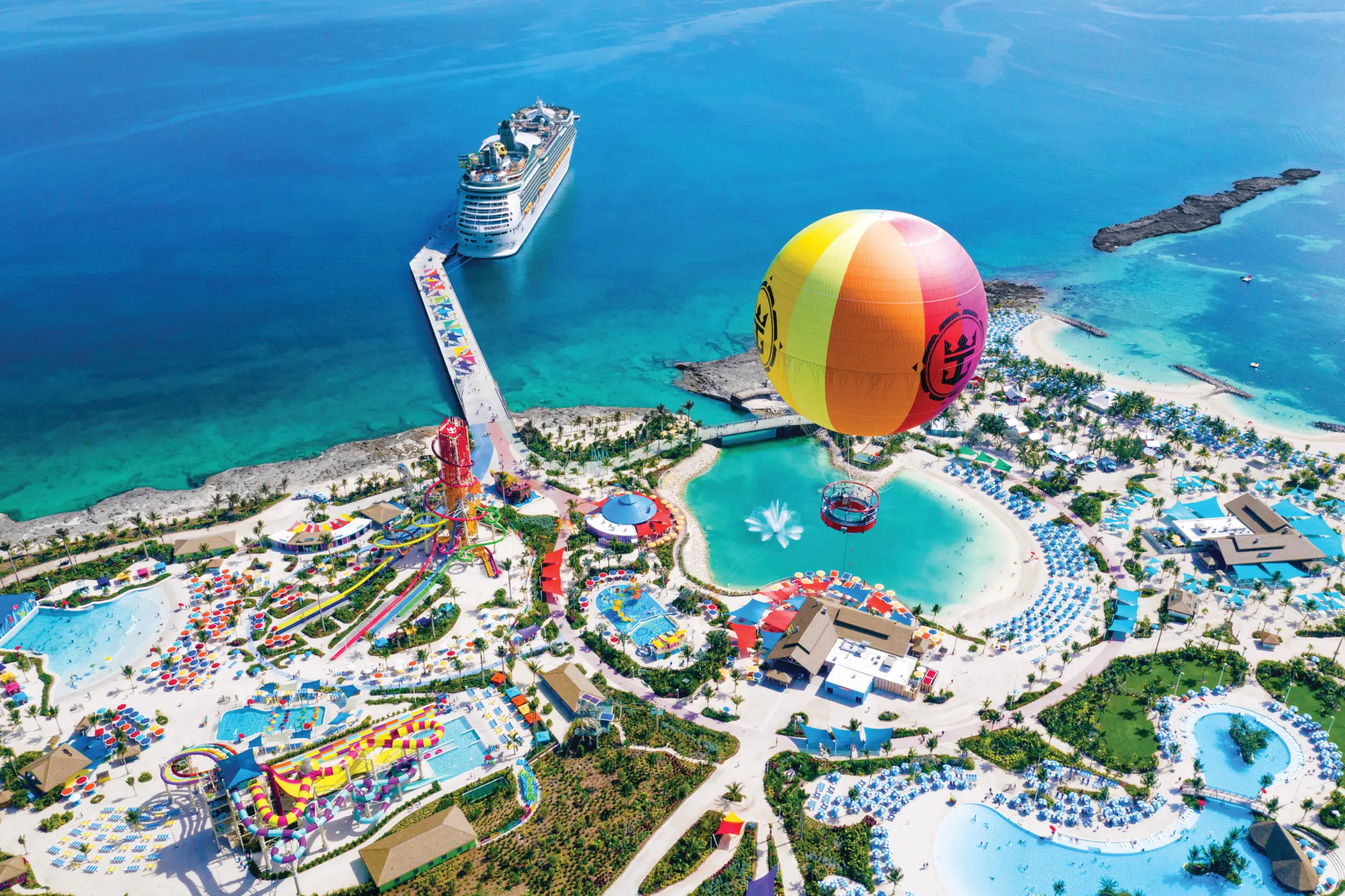 Aerial view of Royal Caribbean's private resort, showing the hot air balloon in flight and the multiple beaches and slides